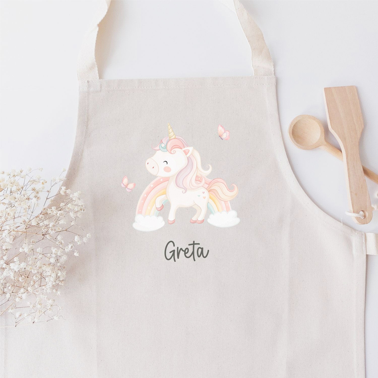 Kinderschürze mit farbigen Einhorn/Regenbogen-Motiv und Name